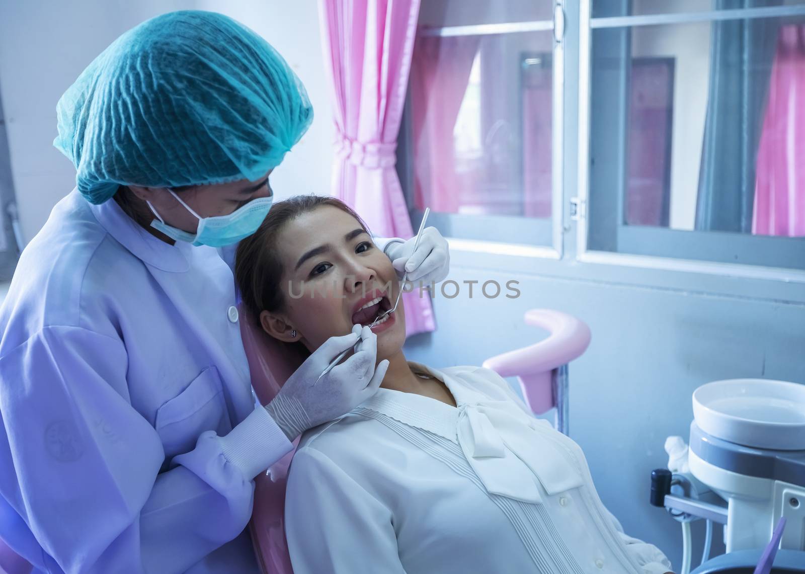 A beautiful woman giving the dentist a dental and oral examinati by numberone9018