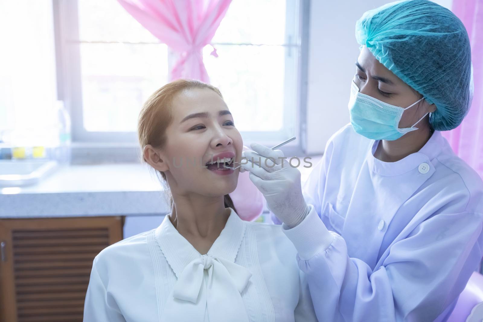 A beautiful woman giving the dentist a dental and oral examination For healthy mouth and teeth