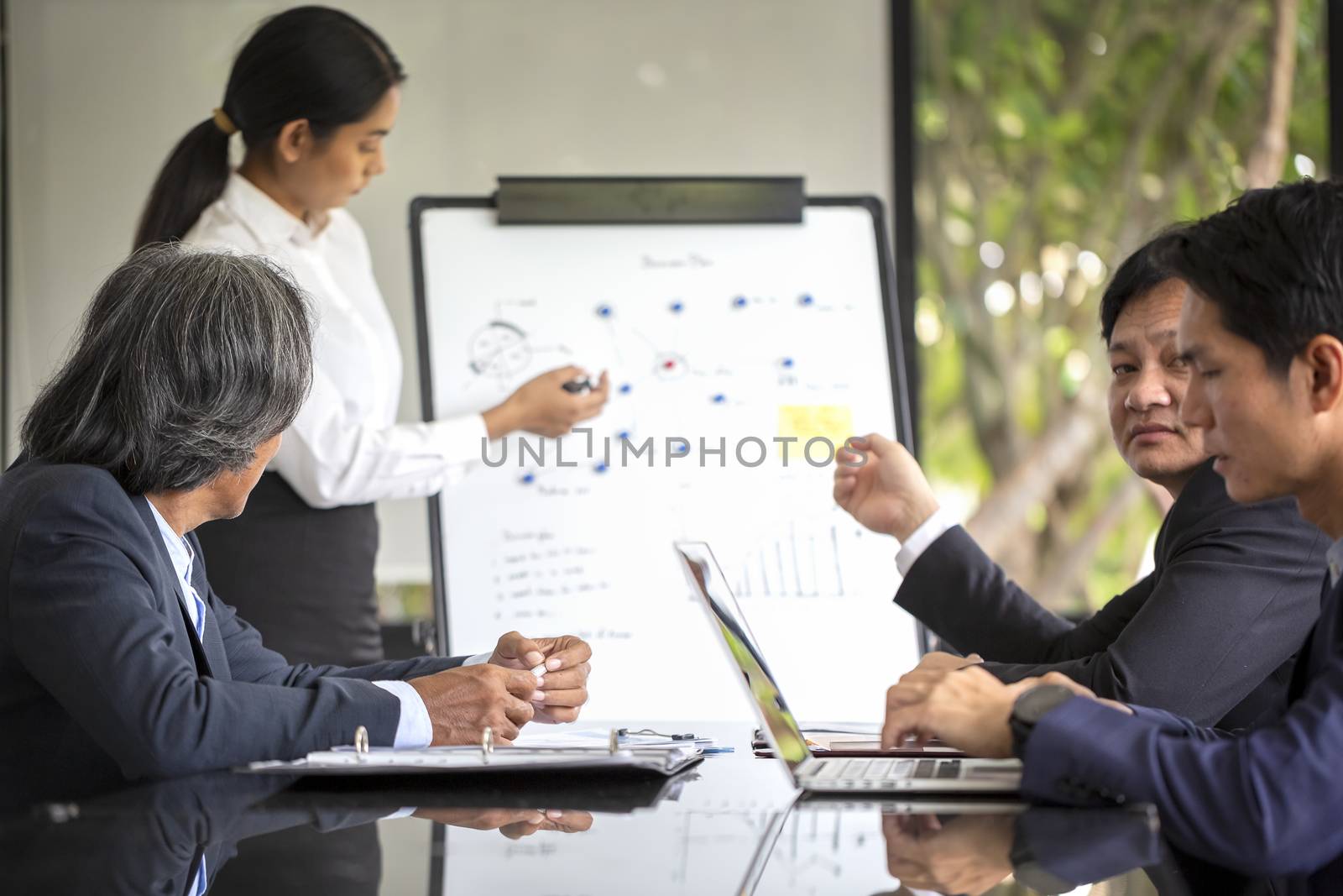 Group of business people planning meeting to conduct an intensive business organization. Business people discussing over new business project in office.