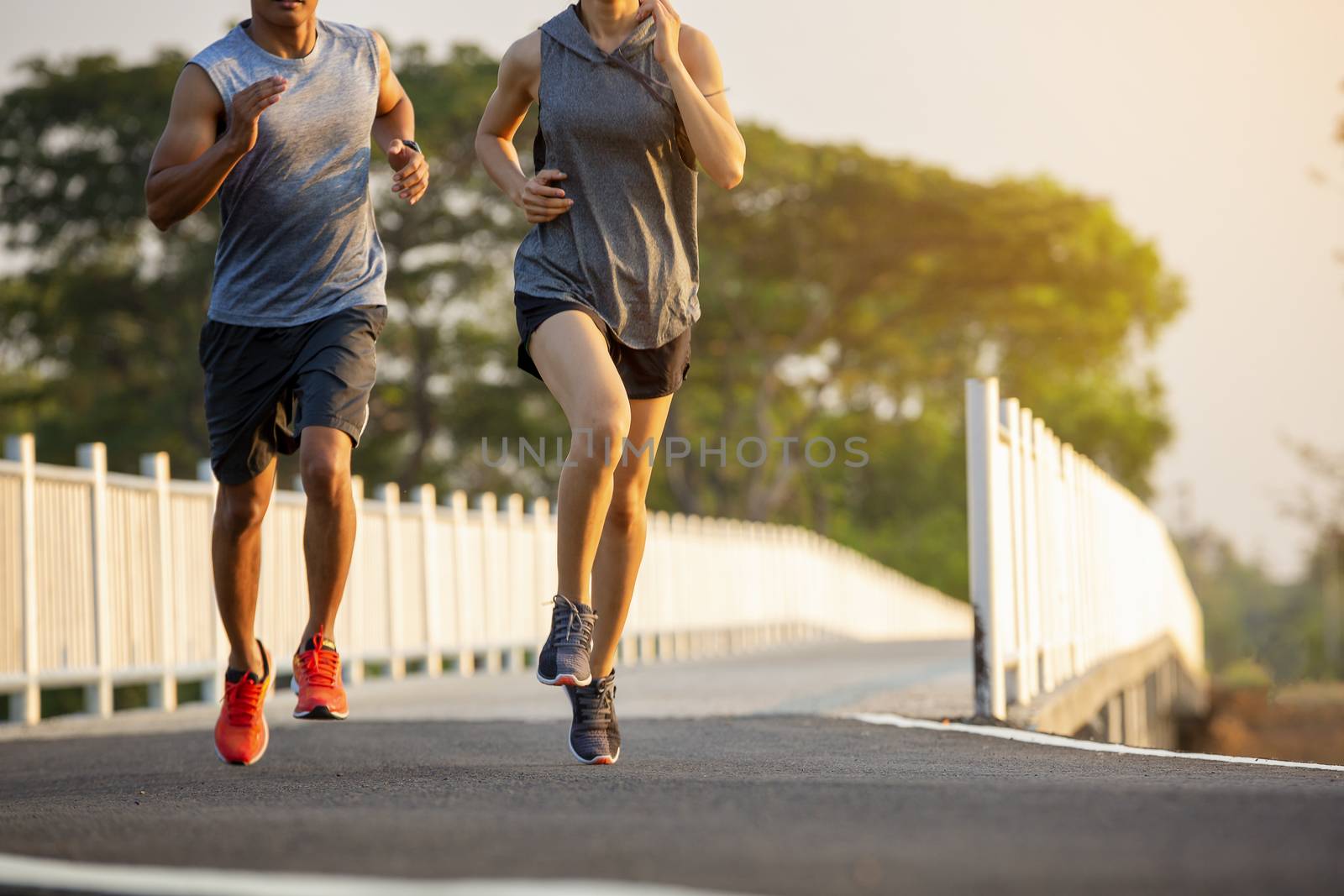 Silhouette of a couple running and exercising at sunset with the by numberone9018