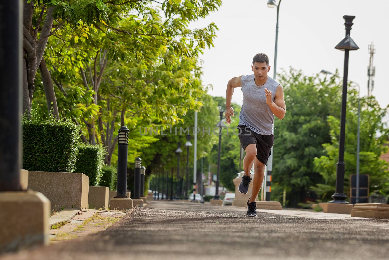 Portrait of handsome man running in the park in early morning. H by numberone9018