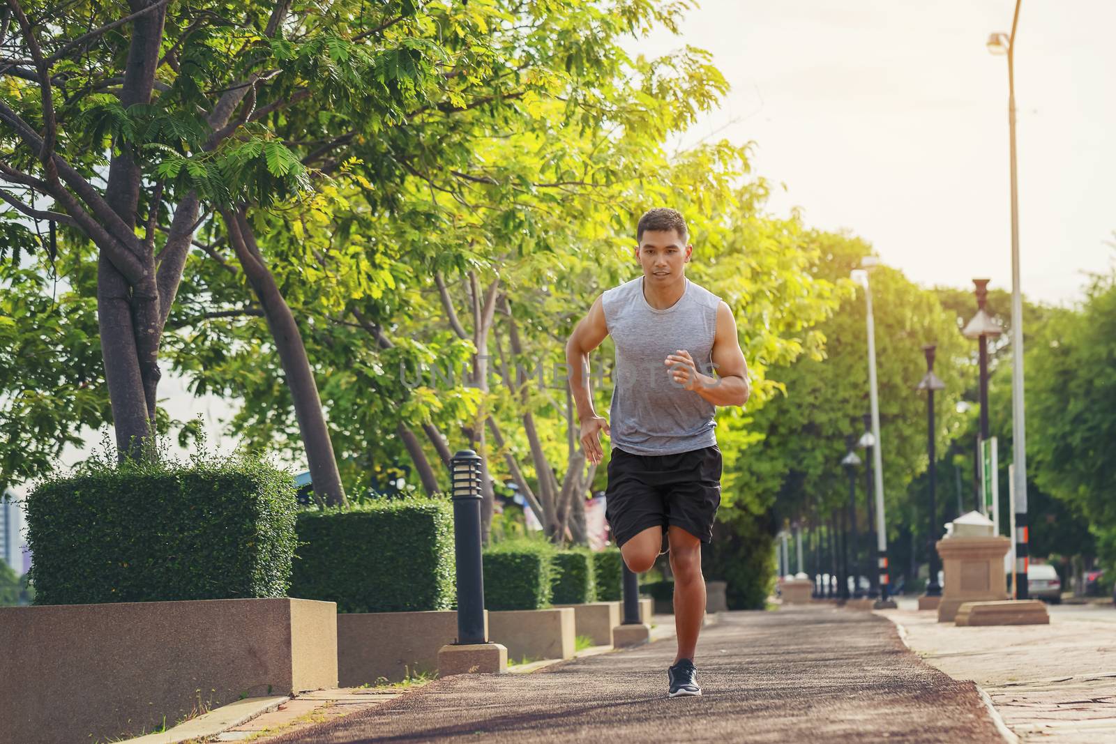 Portrait of handsome man running in the park in early morning. H by numberone9018