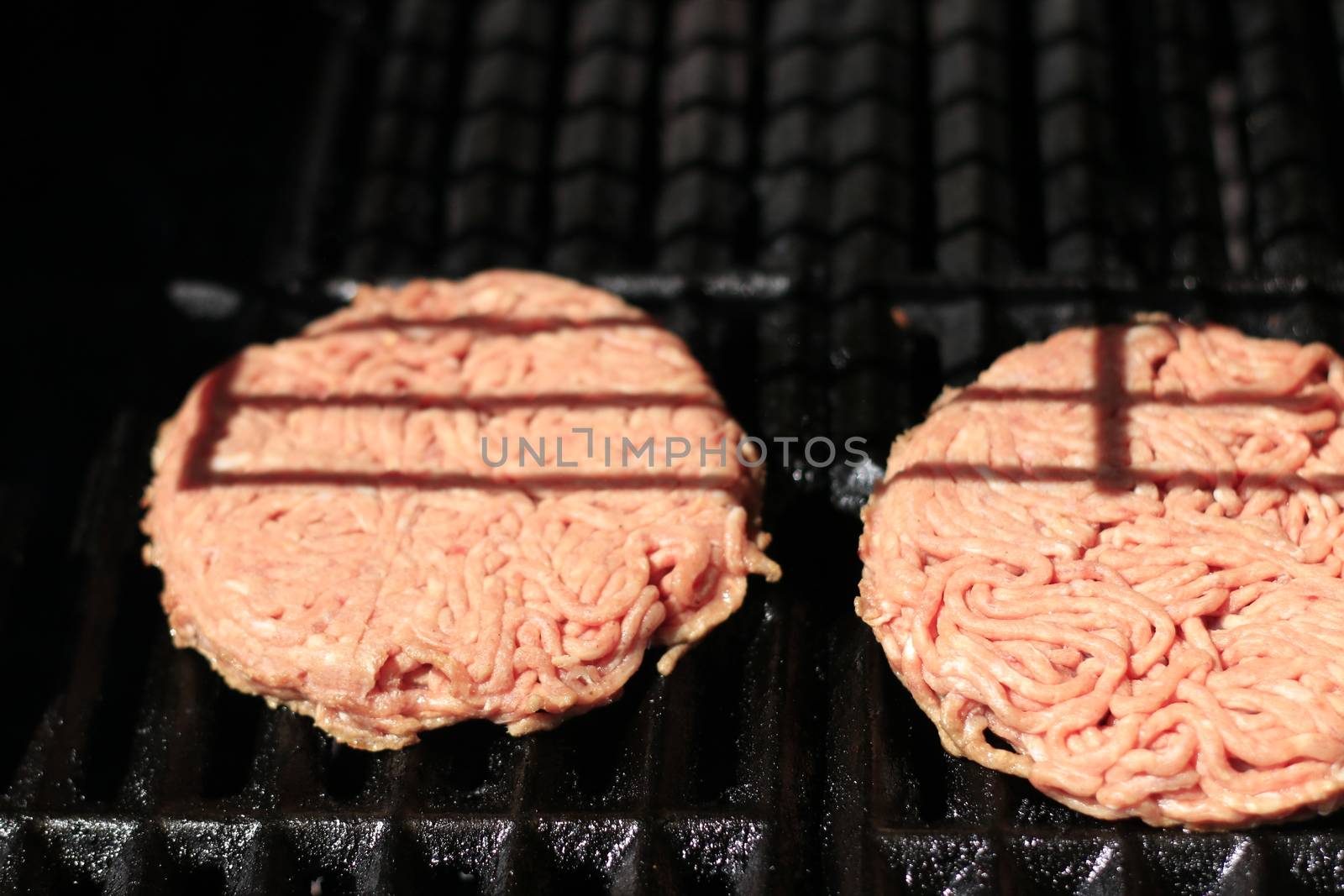 Raw burgers on bbq barbecue grill with fire. Food meat - raw burgers on bbq barbecue grill with fire. 