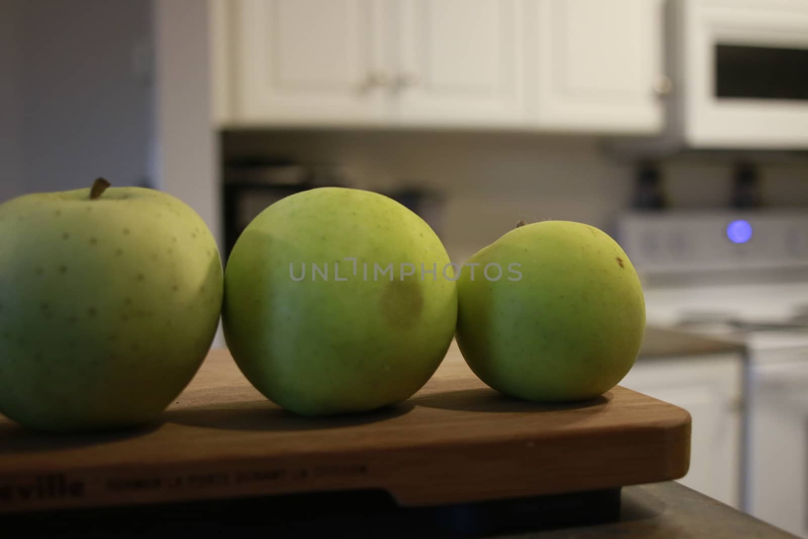green apples in a row. good concept photo by mynewturtle1