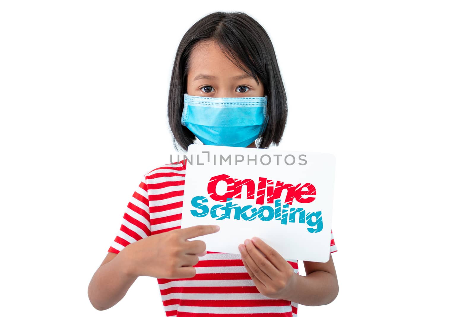 Coronaryvirus and Education Concepts, The girl wearing a mask holding a paper with a message "Online Schooling" To encourage everyone to work together to teach children at home.