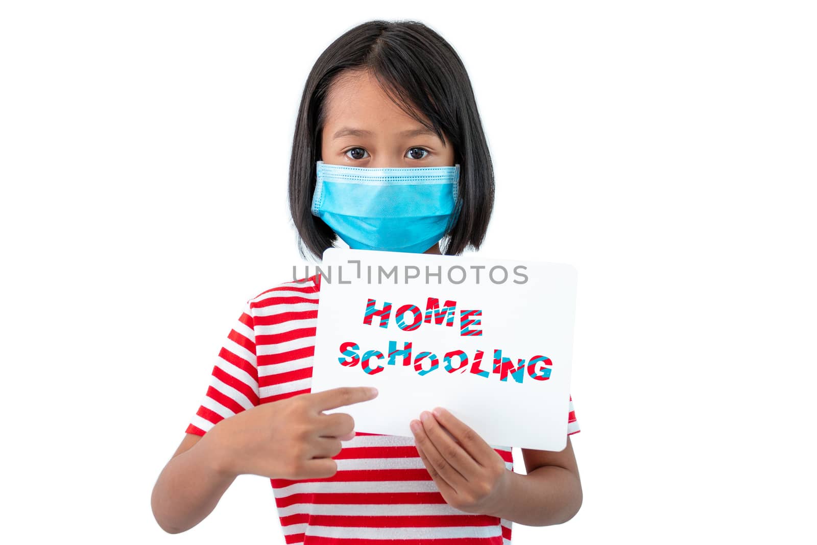 Coronaryvirus and Education Concepts, The girl wearing a mask holding a paper with a message "Home Schooling" To encourage everyone to work together to teach children at home.
