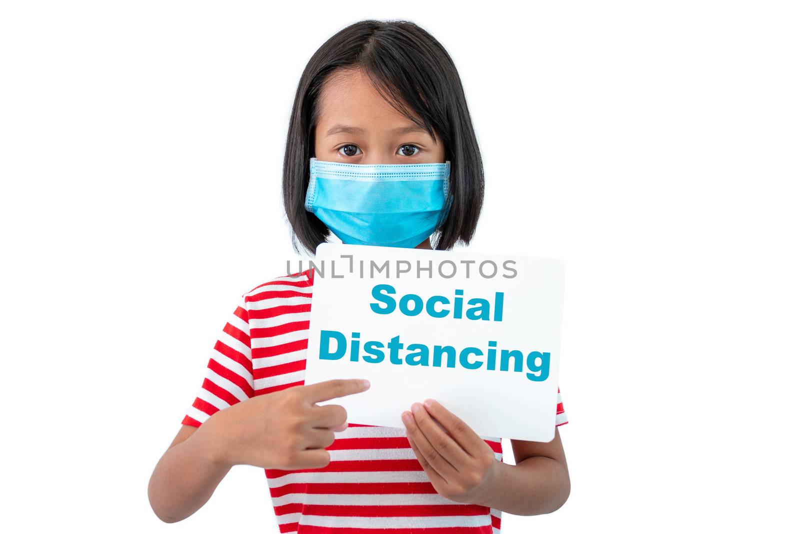 Coronavirus Outbreak. Lockdown and school closures. School girl in face mask holding a sign with the words "Social Distancing"