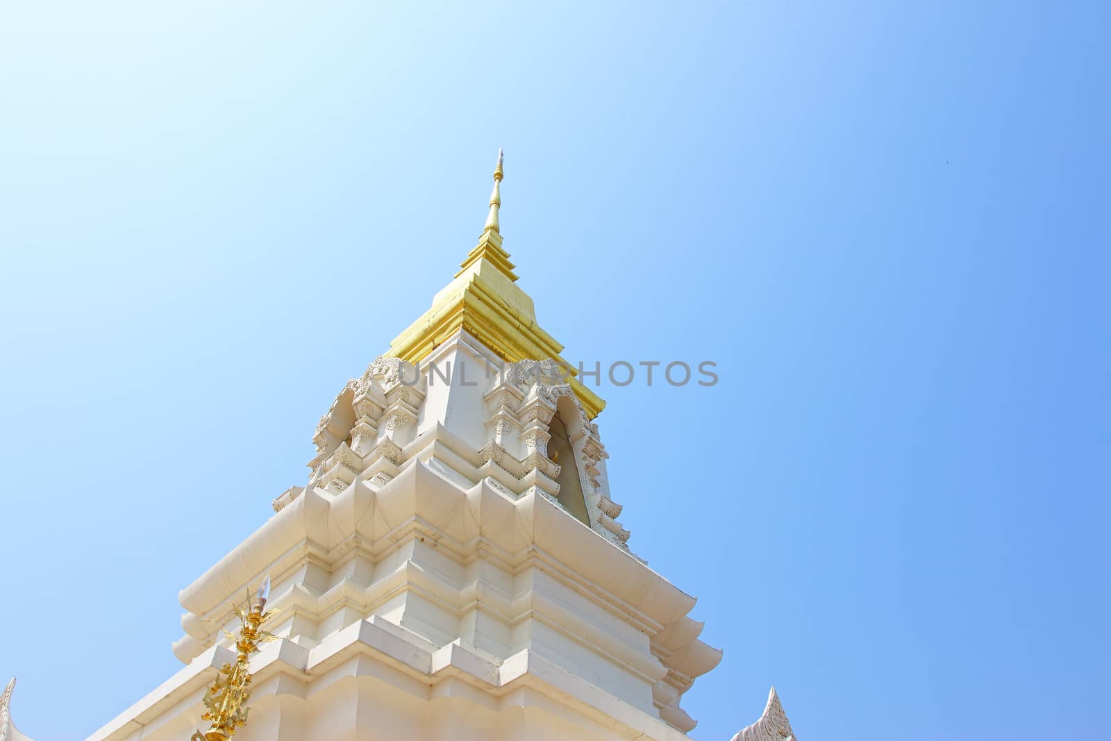 Religious architecture and beliefs, a beautiful white Thai temple on a blue sky