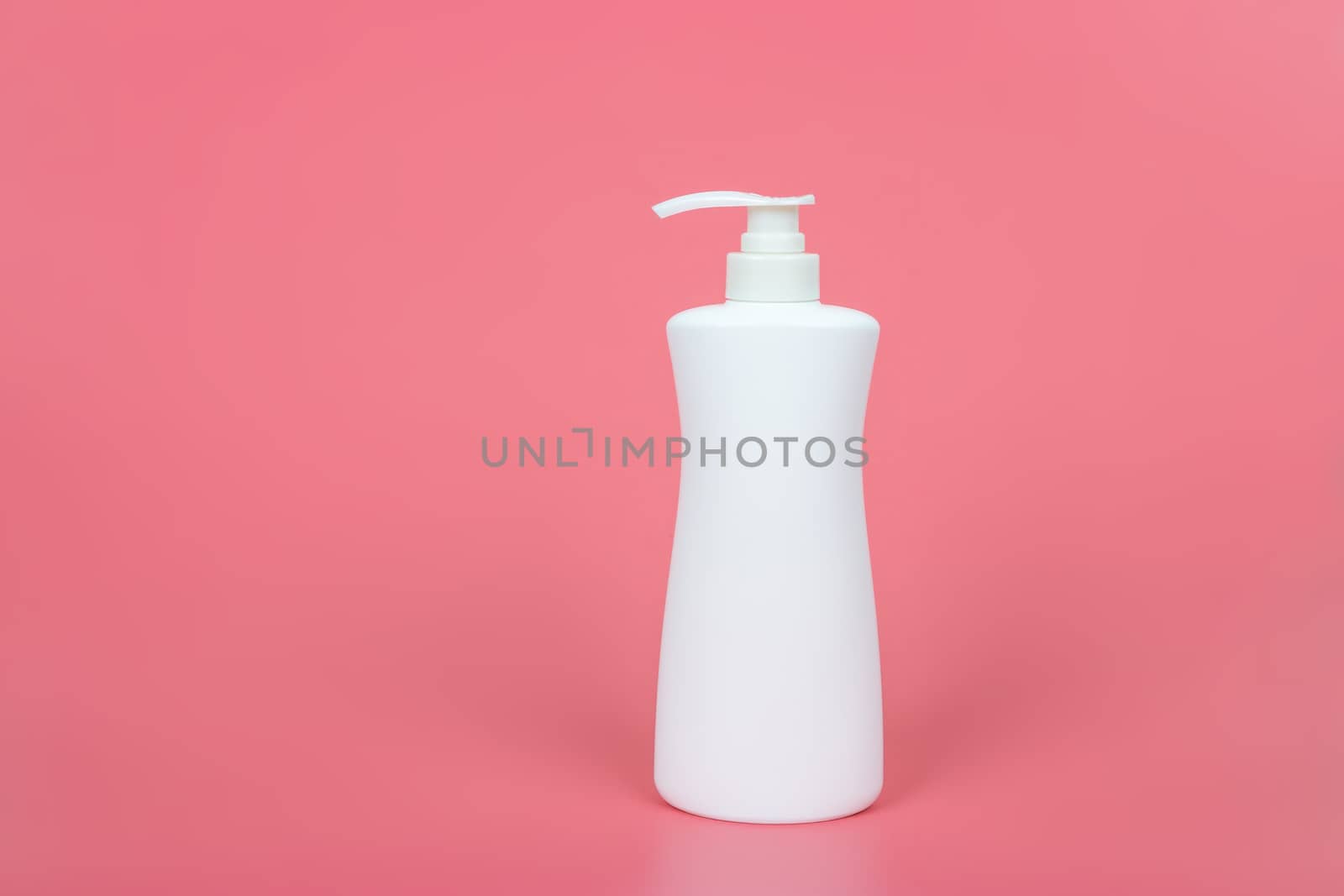 Cosmetic mock up bottle on pastel pink background