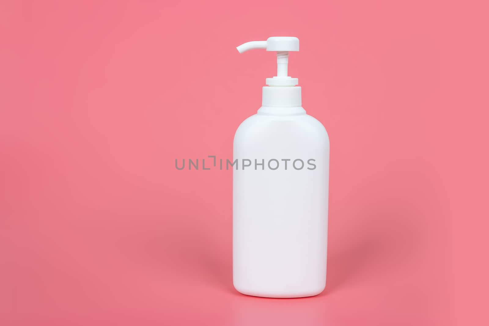 Cosmetic mock up bottle on pastel pink background