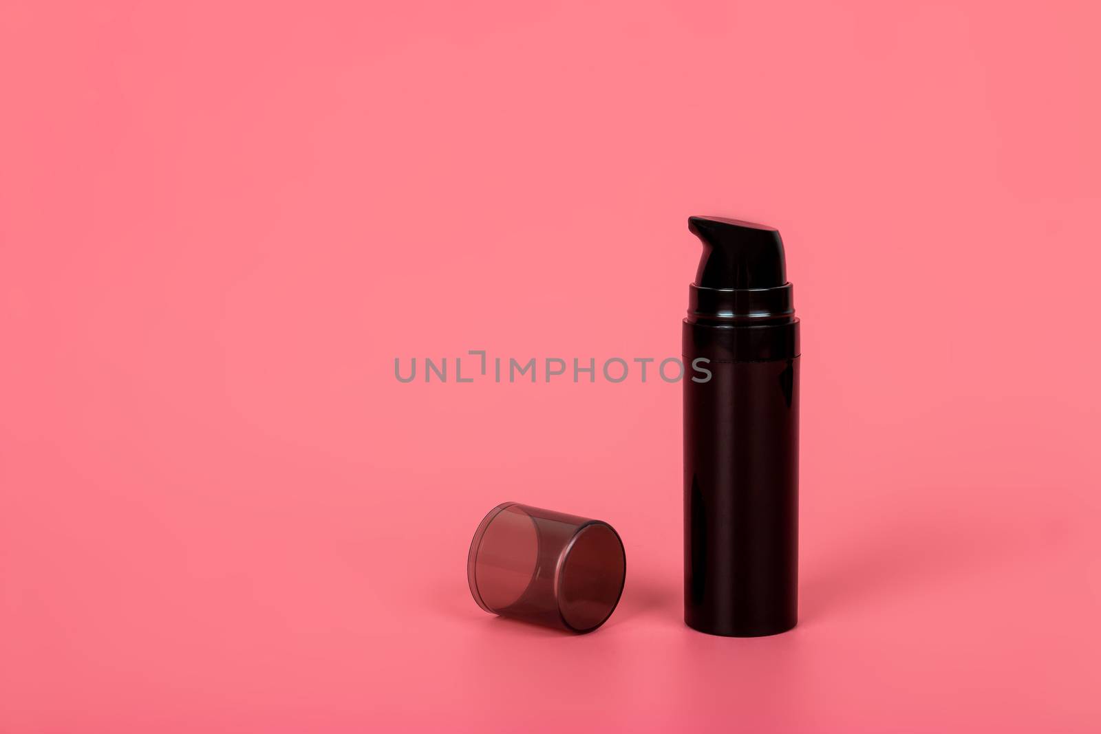 Cosmetic mock up bottle on pastel pink background