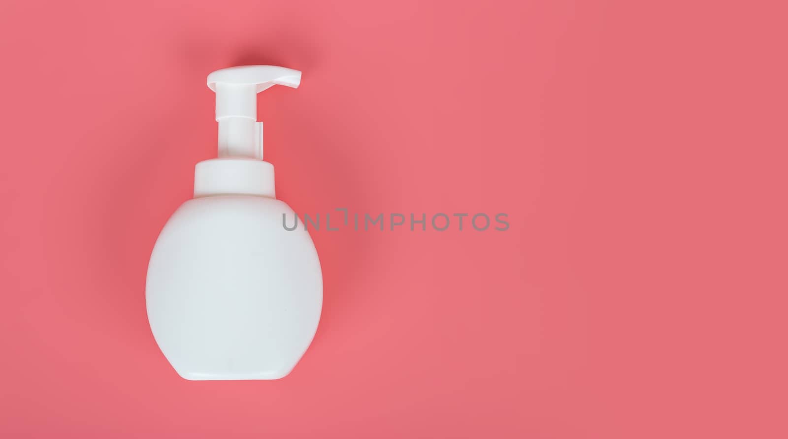 Cosmetic mock up bottle on pastel pink background