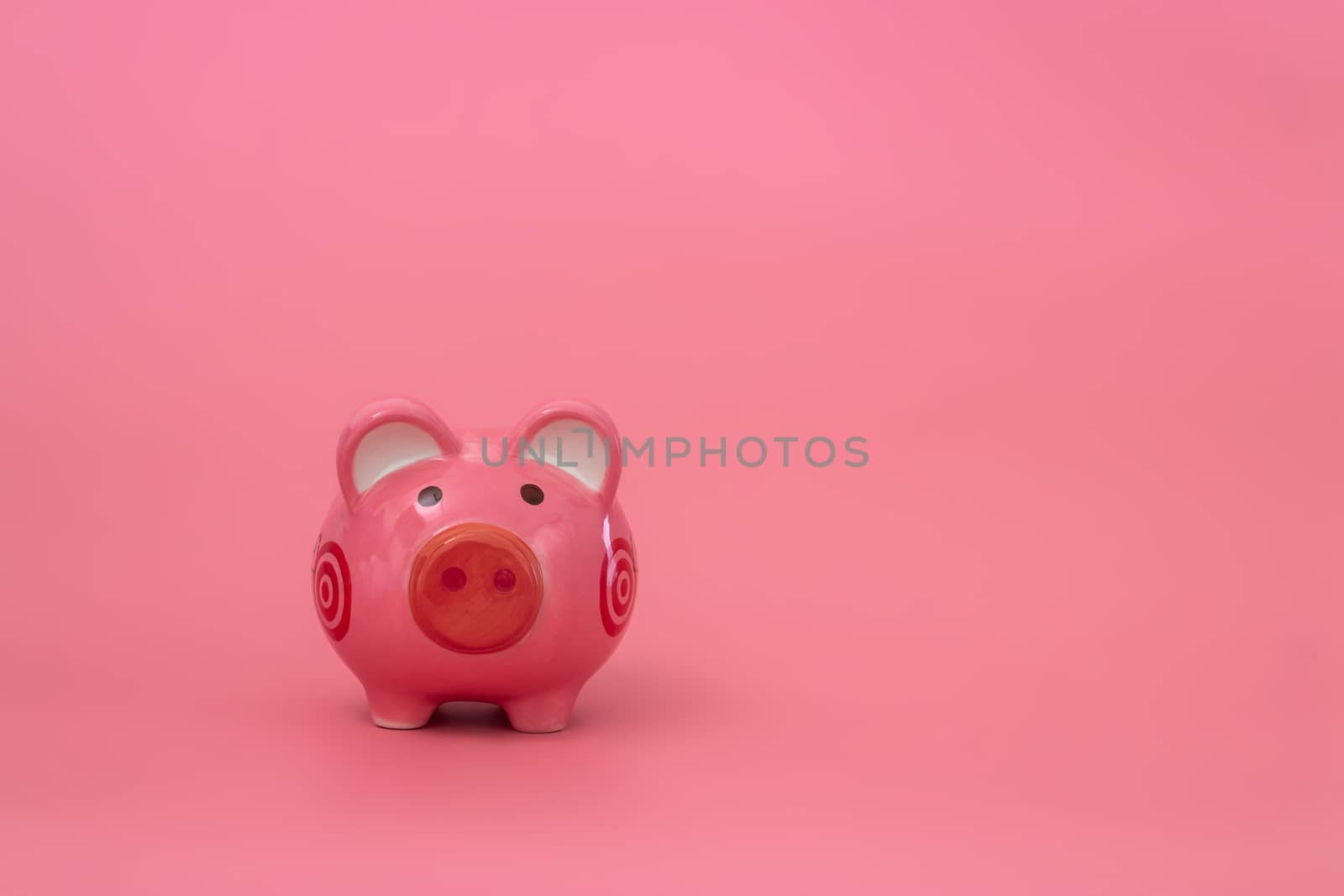 Pink piggy bank on pastel pink background, Financial concepts