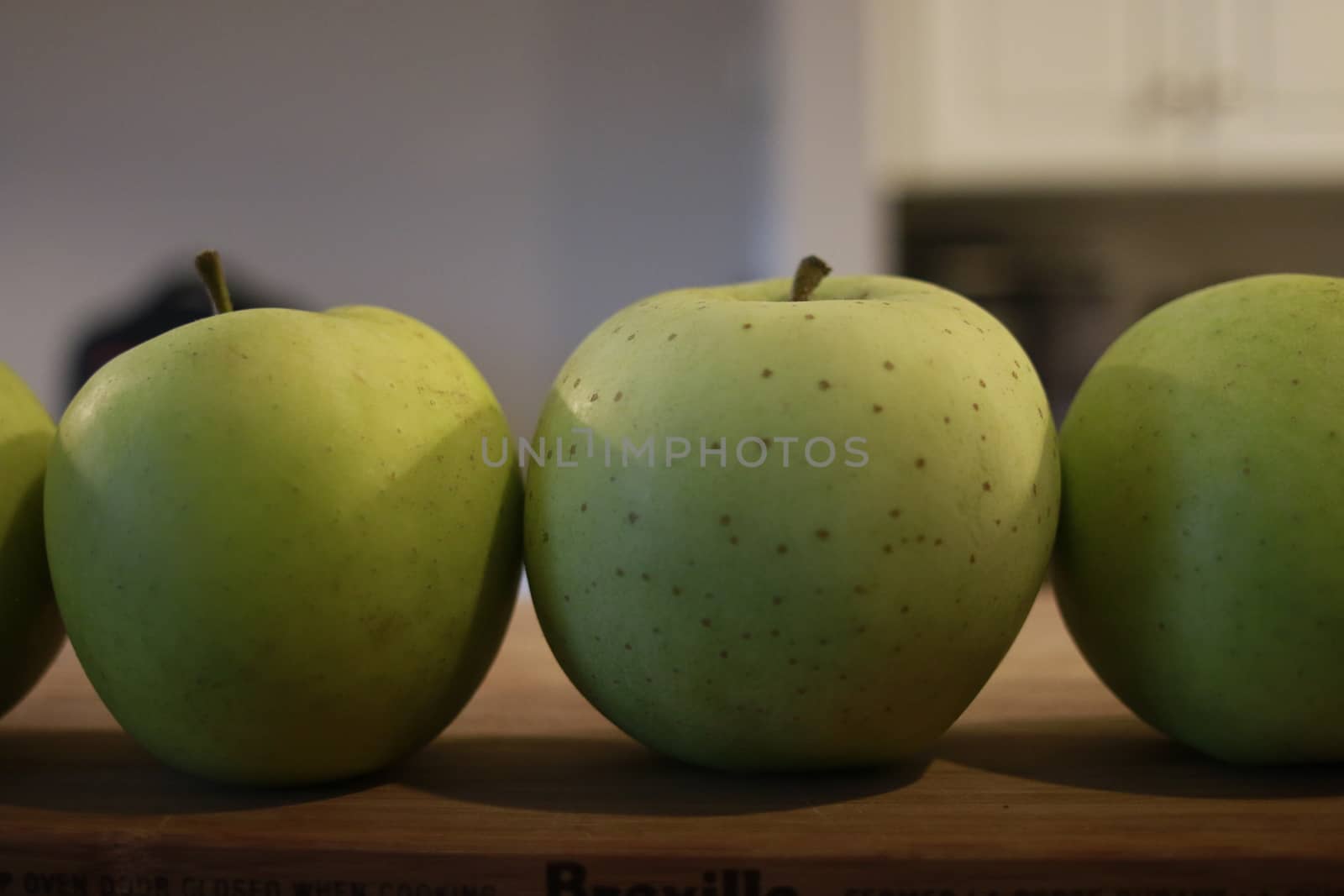 green apples in a row. good concept photo by mynewturtle1