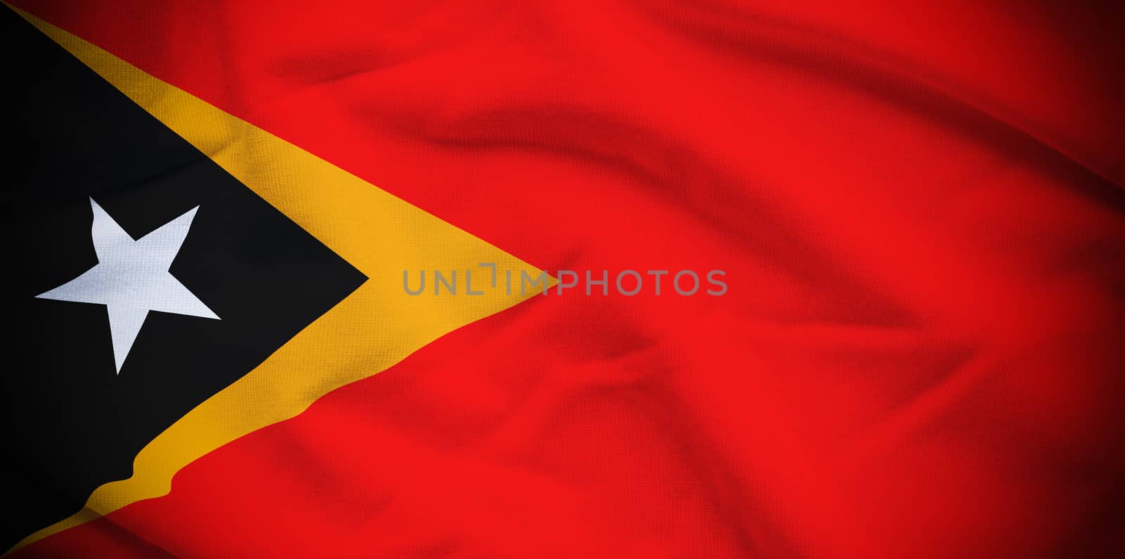 Wavy and rippled national flag of East Timor background.