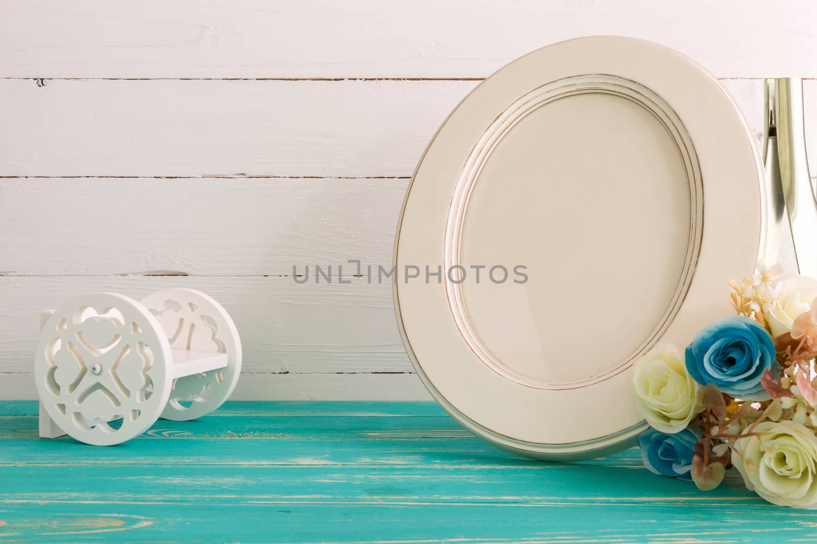 White vintage photo frame on table with decoration background.