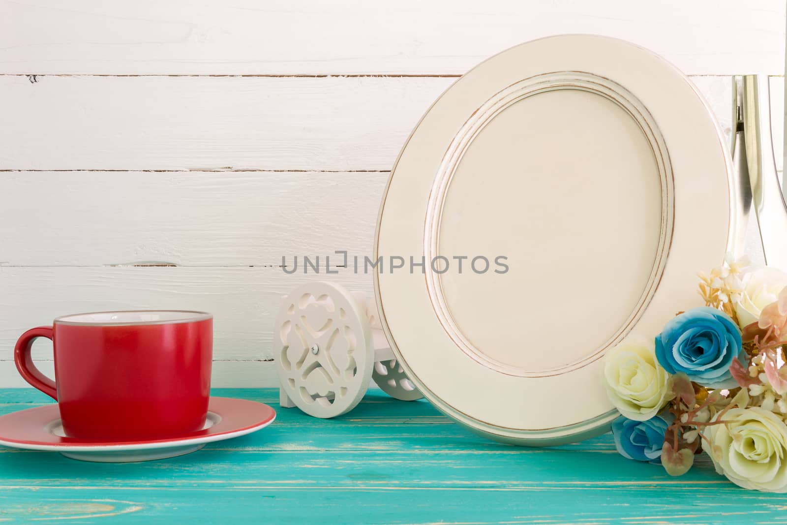 White vintage photo frame on table with decoration background.