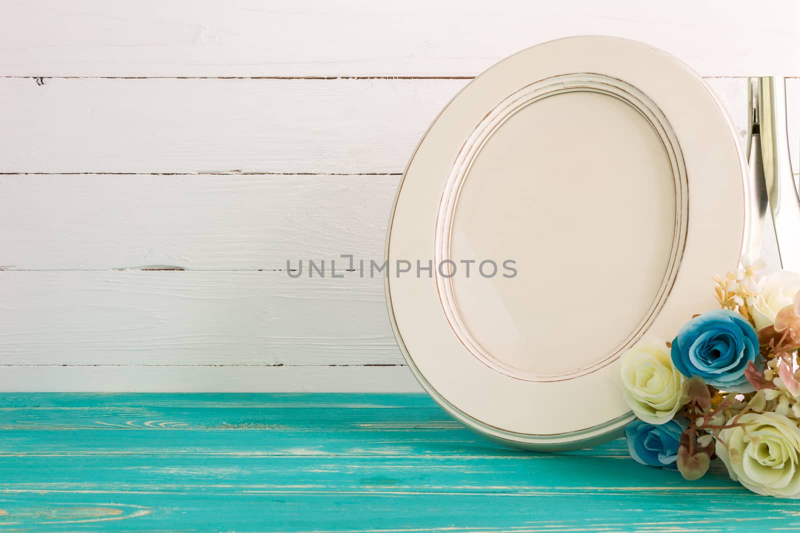 White vintage photo frame on table with decoration background.