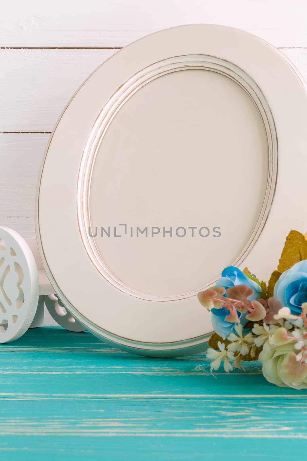 White vintage photo frame on table with decoration background.