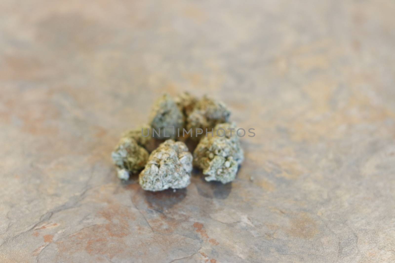 group of marijuana buds on a table top by mynewturtle1