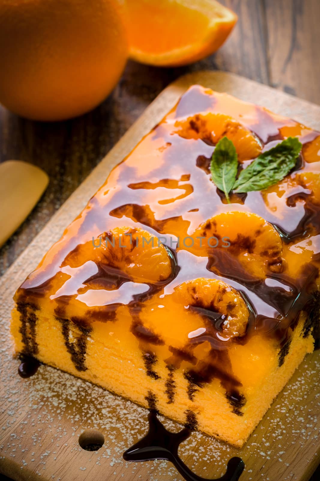 Orange cake with chocolate sauce for tea break.