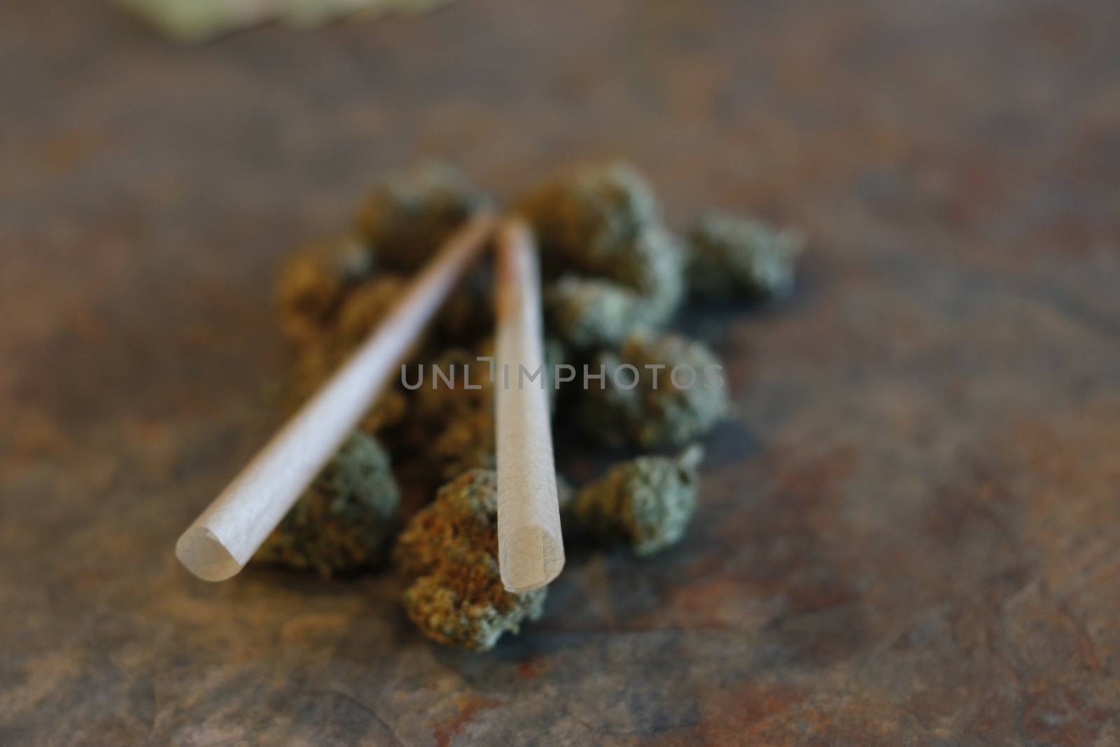 closeup of dried marijuana and handmade cigarette in ashtray. by mynewturtle1
