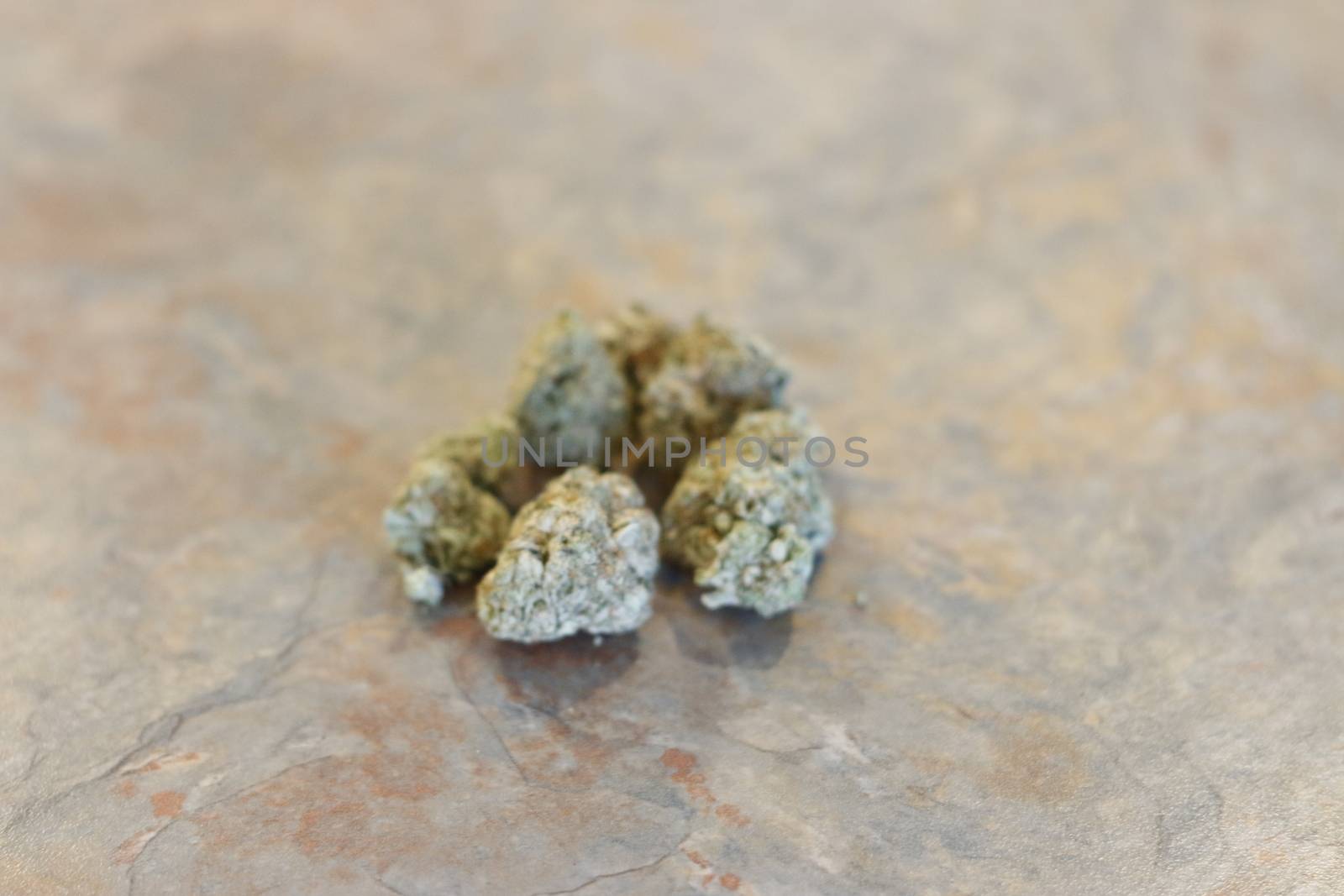 group of marijuana buds on a table top.