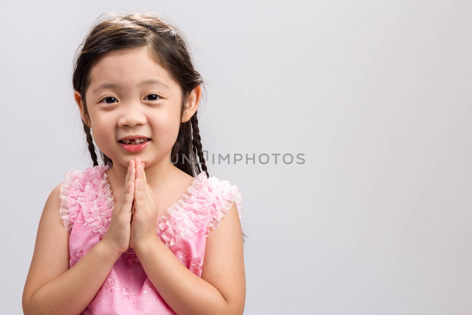 Thai child in traditional Thai costume on white background.