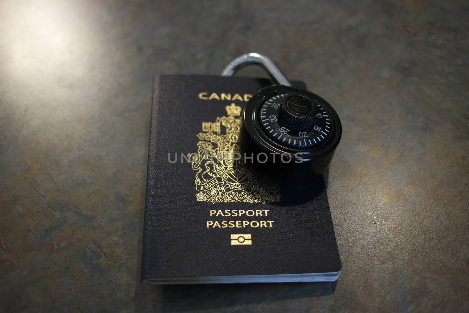 A lock on a Canadian passport. Theme of refugee crisis or open borders by mynewturtle1