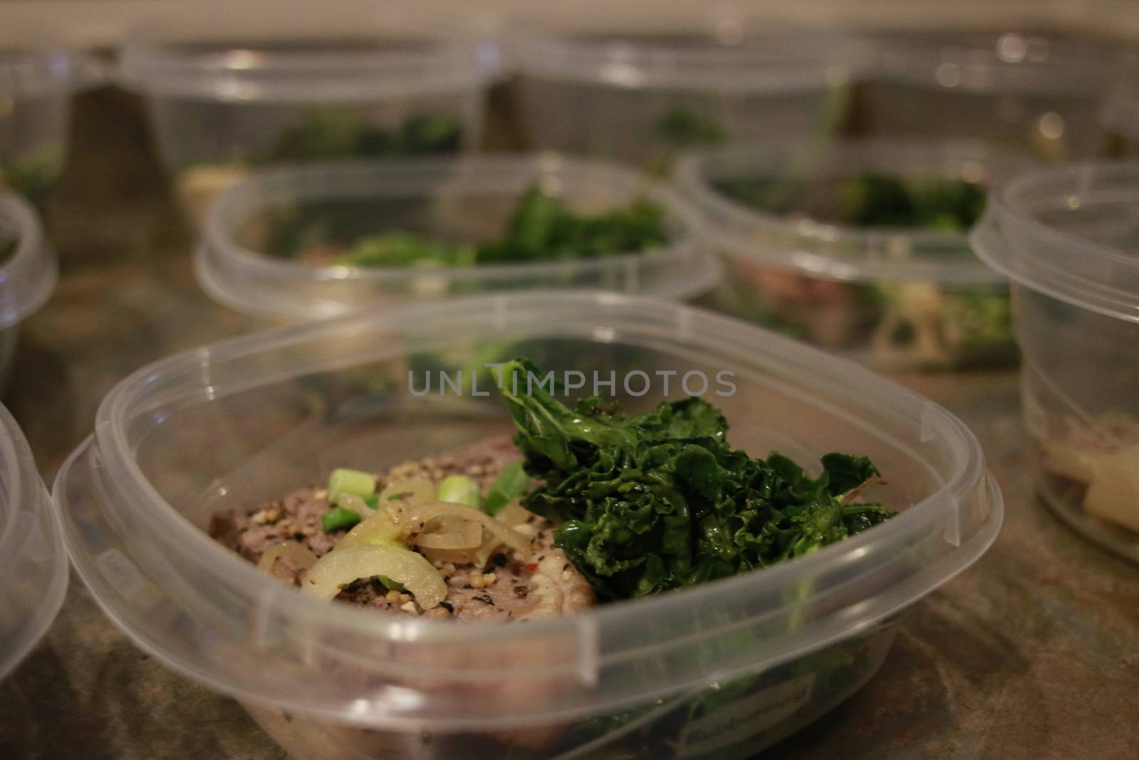 Healthy meal prep containers with quinoa, chicken and cole slaw.