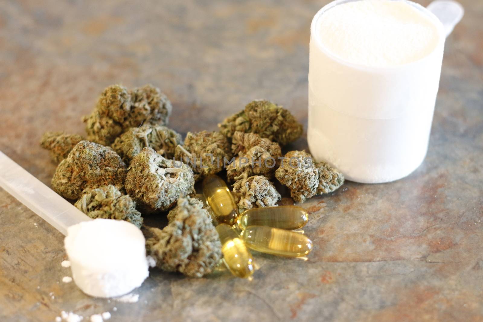 Buds of marijuana next to a scoop of protein and creatine with fish oil pills in front by mynewturtle1