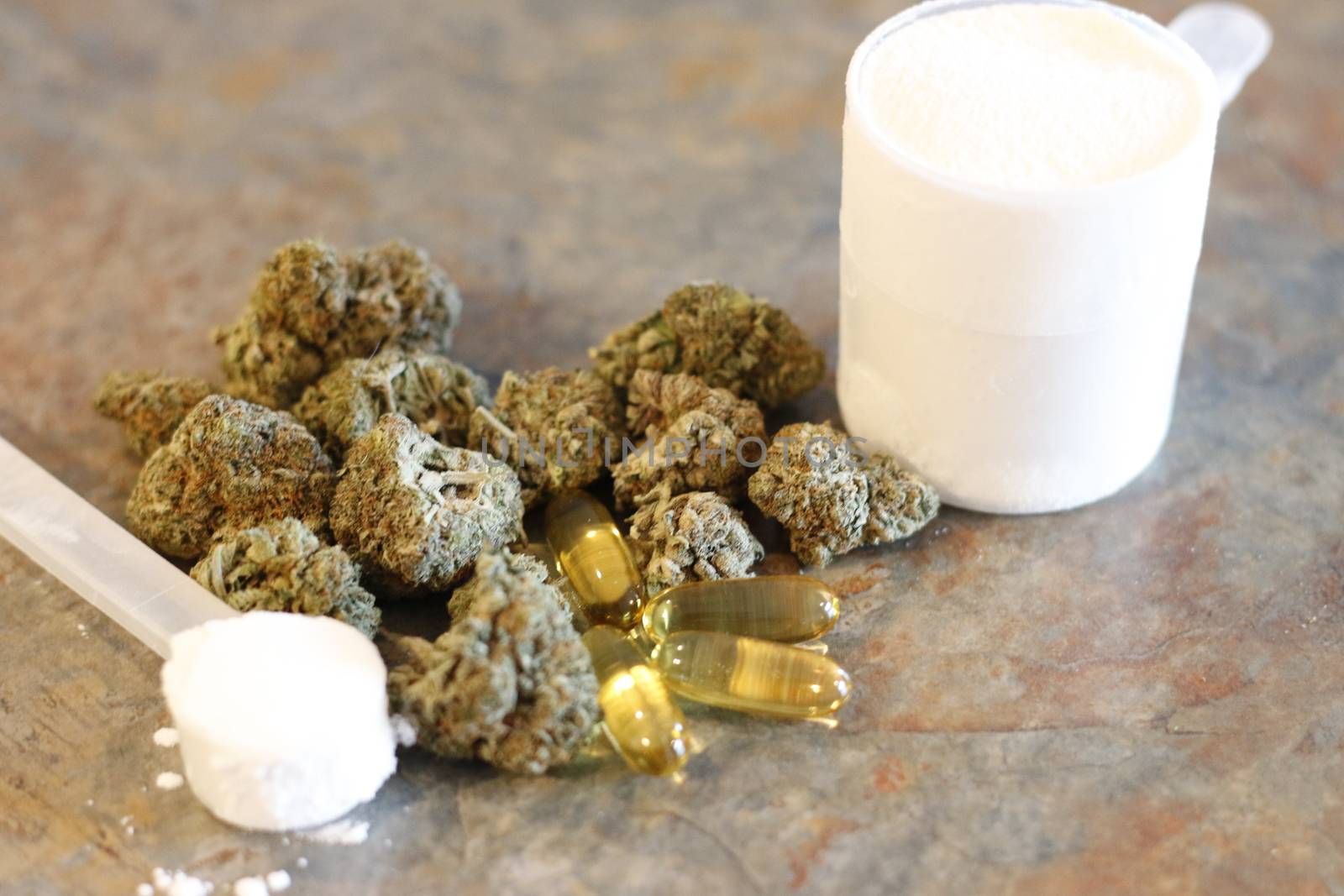 Buds of marijuana next to a scoop of protein and creatine with fish oil pills in front by mynewturtle1