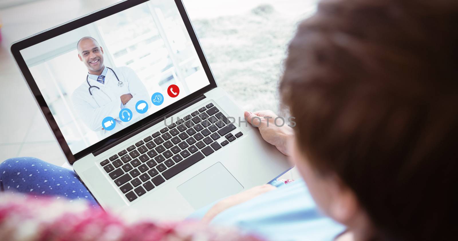 Pregnant woman using her laptop against confident male doctor smiling at camera