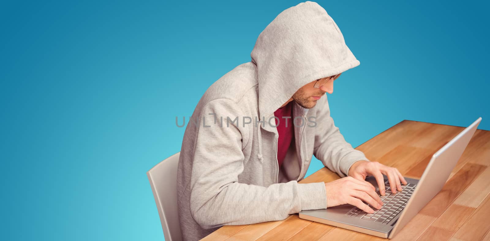 Businessman with hooded shirt working on laptop against blue vignette background