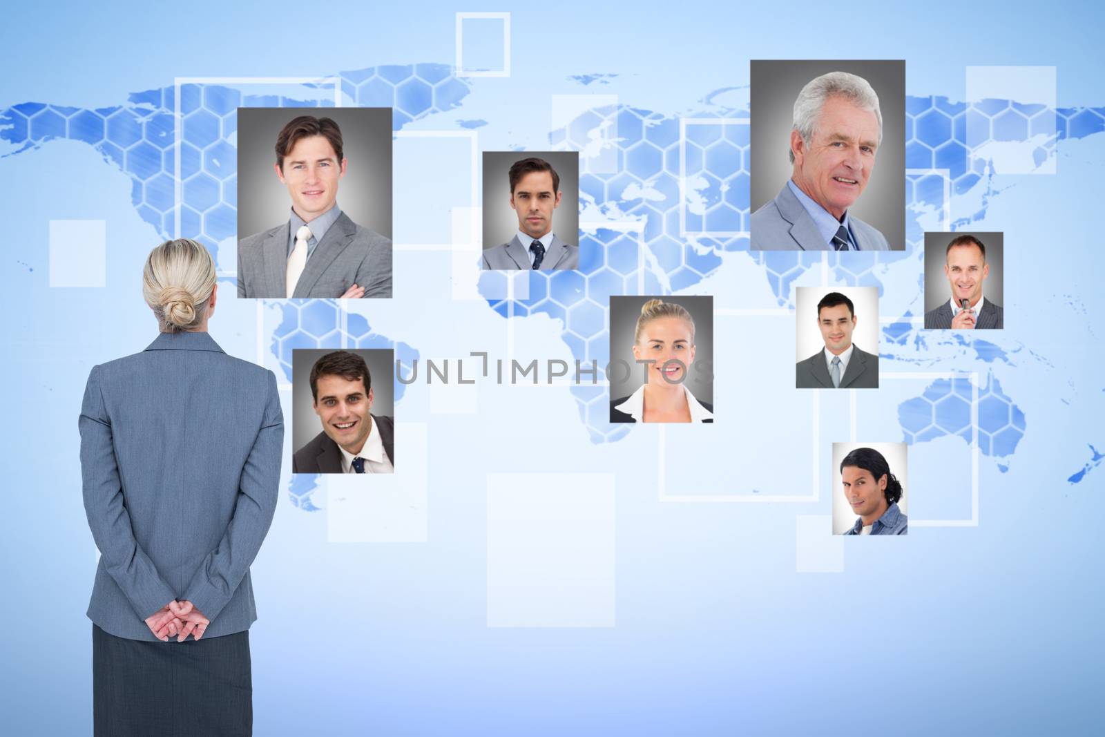 Businesswoman standing with hands behind back against background with world map
