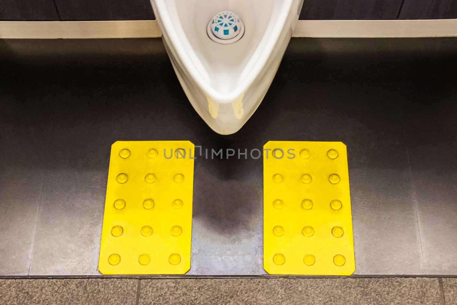 White ceramic urinals in men's bathroom design for the visually impaired. Japan