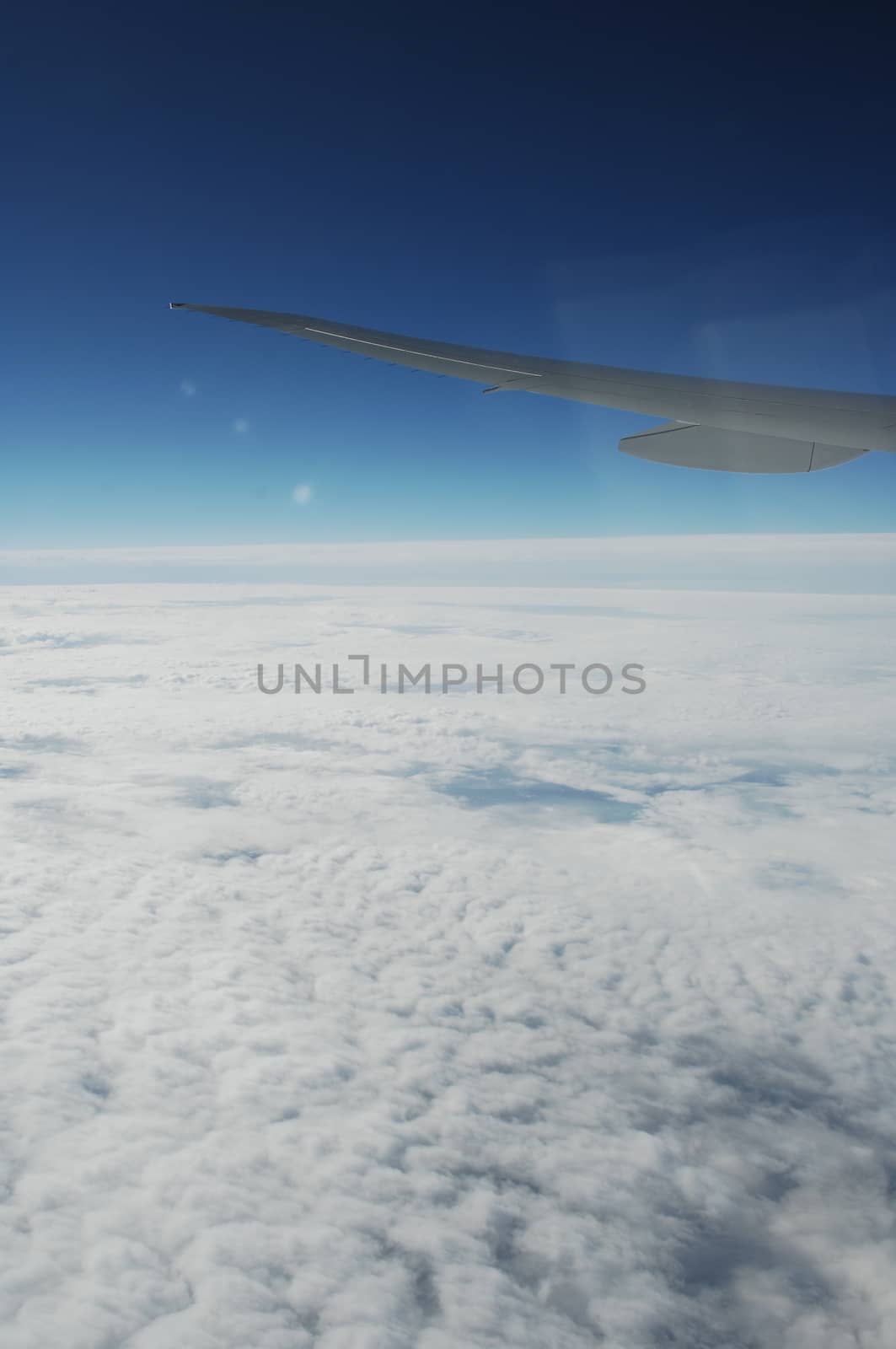 Aerial view of Clouds through flight window