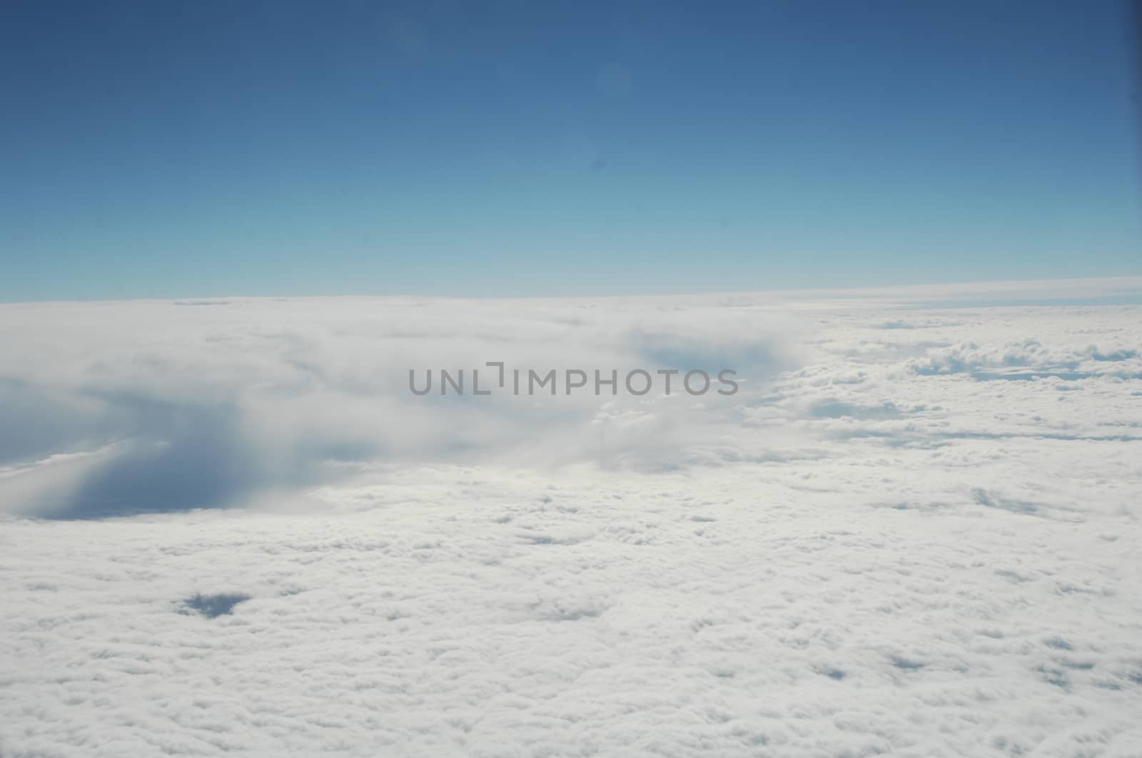 Aerial view of Clouds through flight window