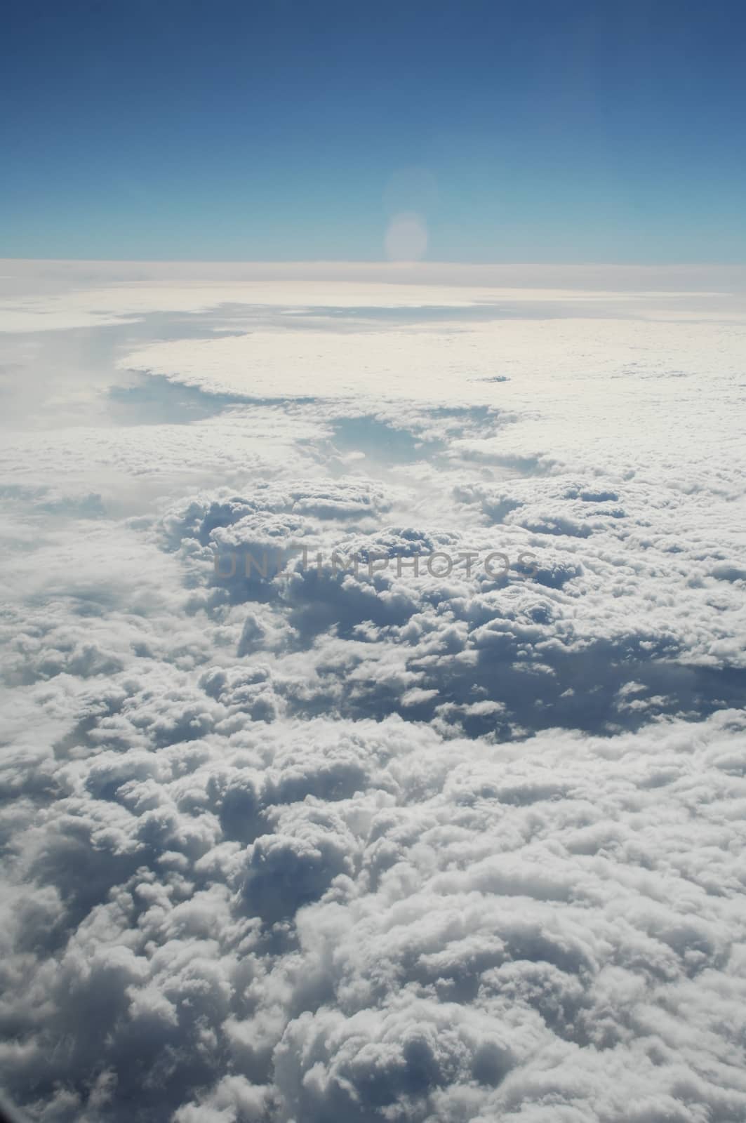 Aerial view of Clouds through flight window