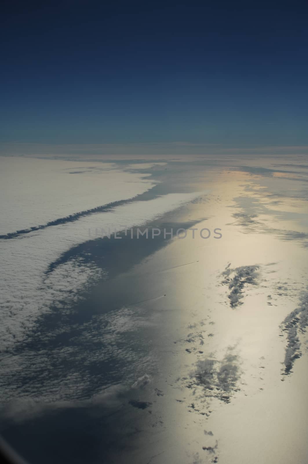 Aerial view of Clouds through flight window