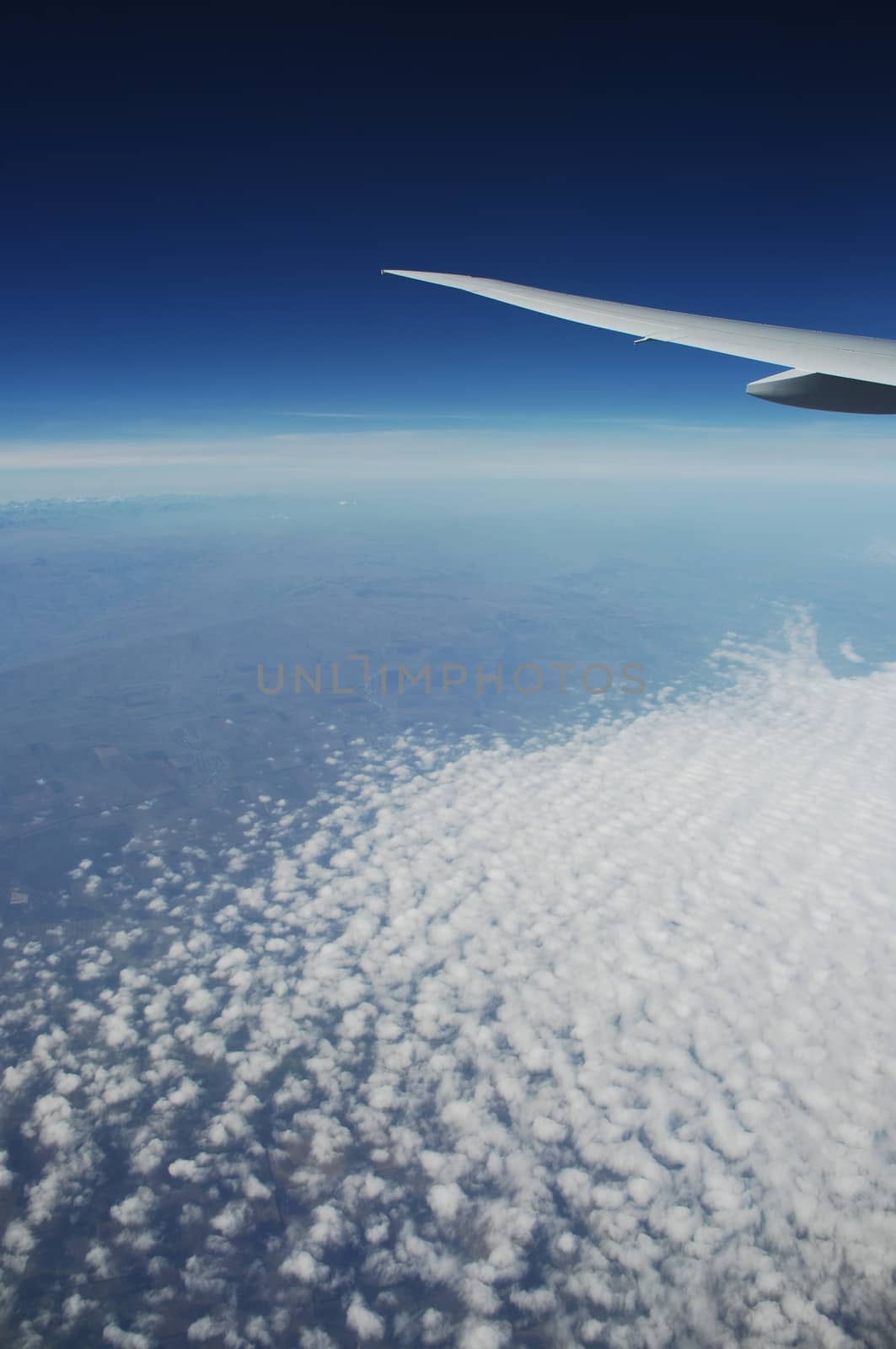 Aerial view of Clouds through flight window