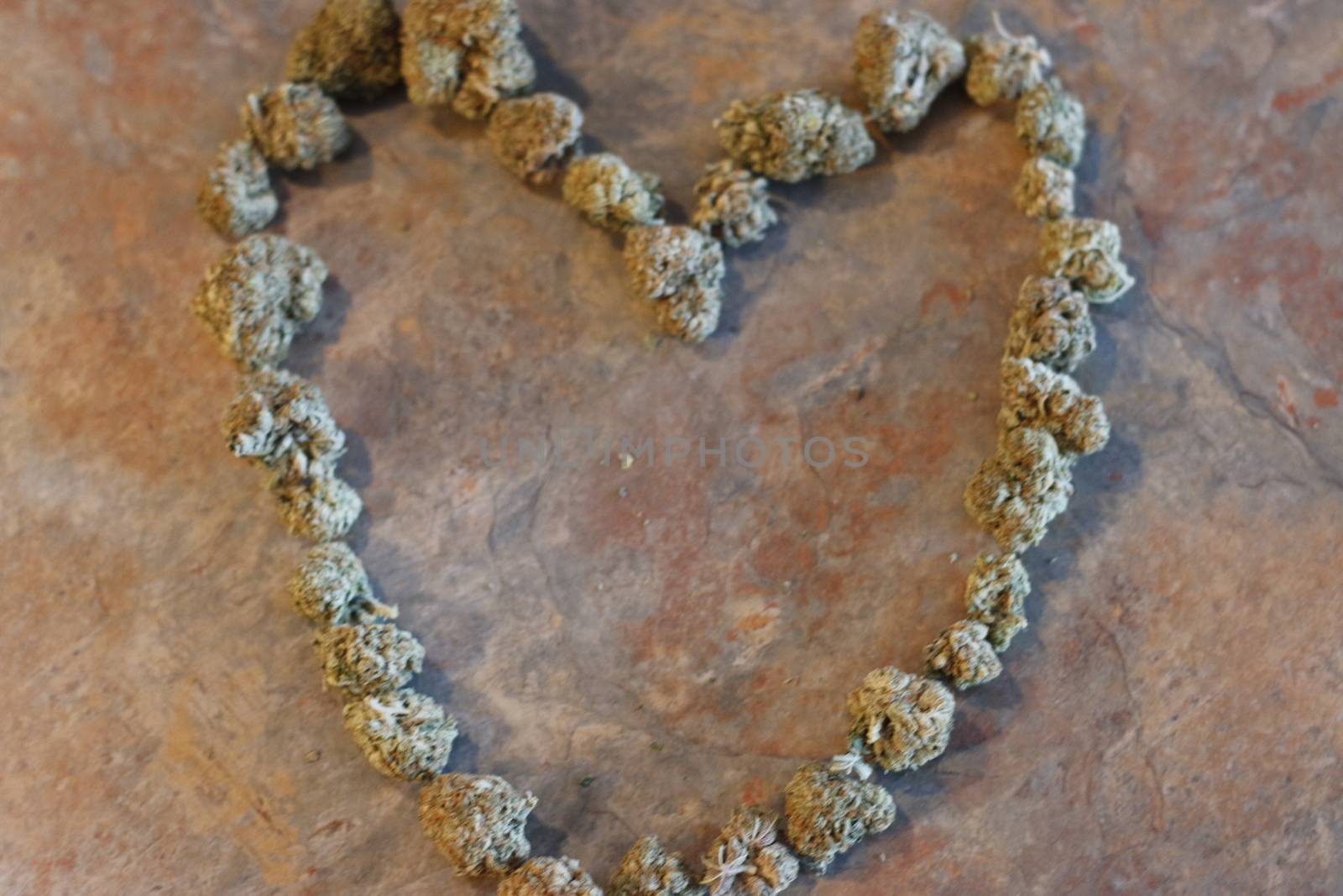 The shape of a heart made out of cannabis buds .