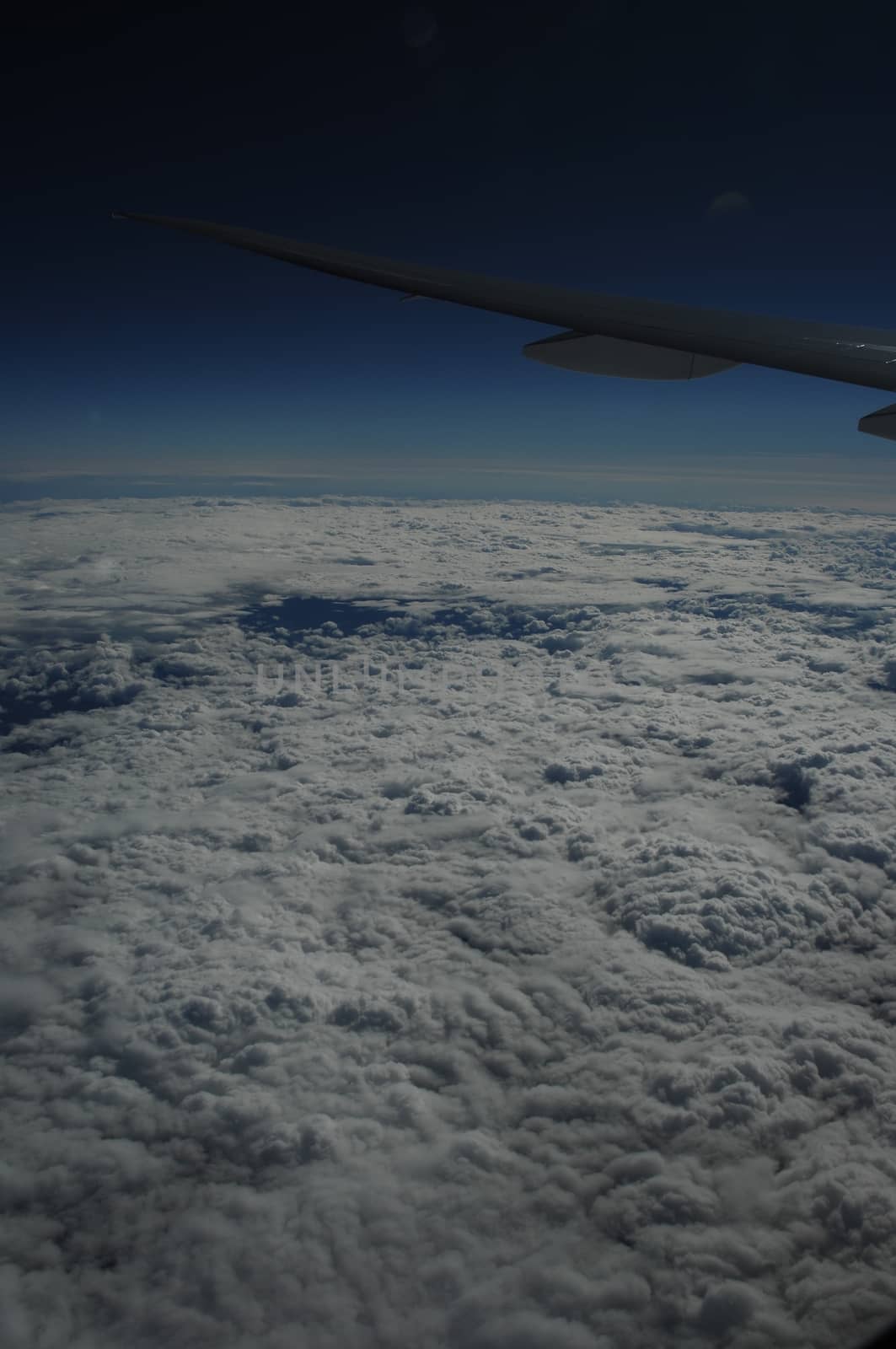 Aerial view of Clouds through flight window