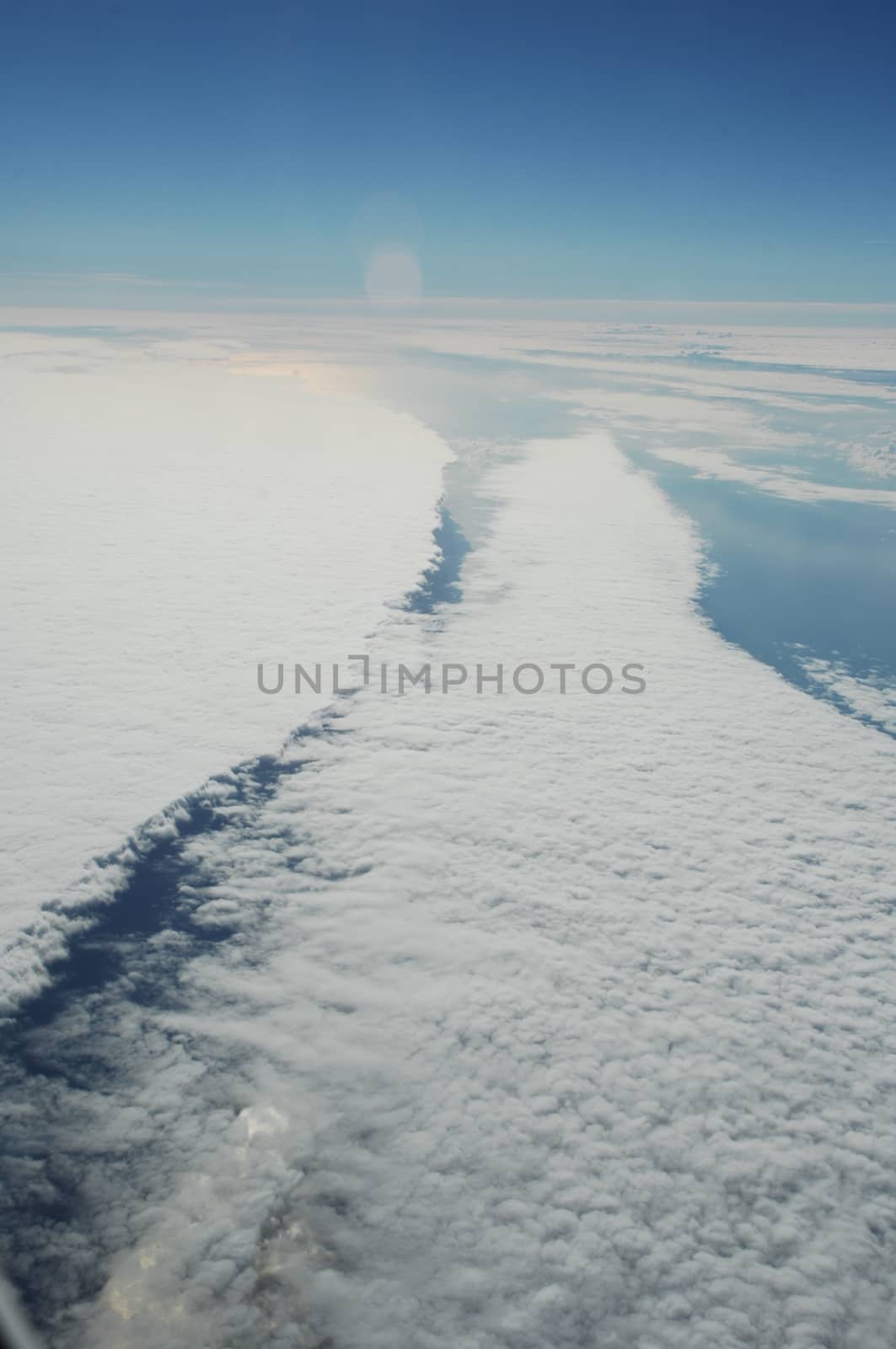 Aerial view of Clouds through flight window