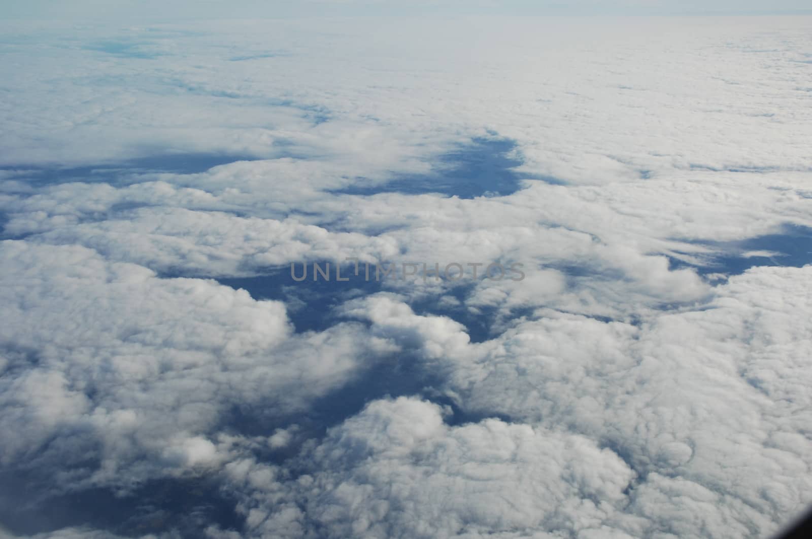 Aerial view of Clouds through flight window
