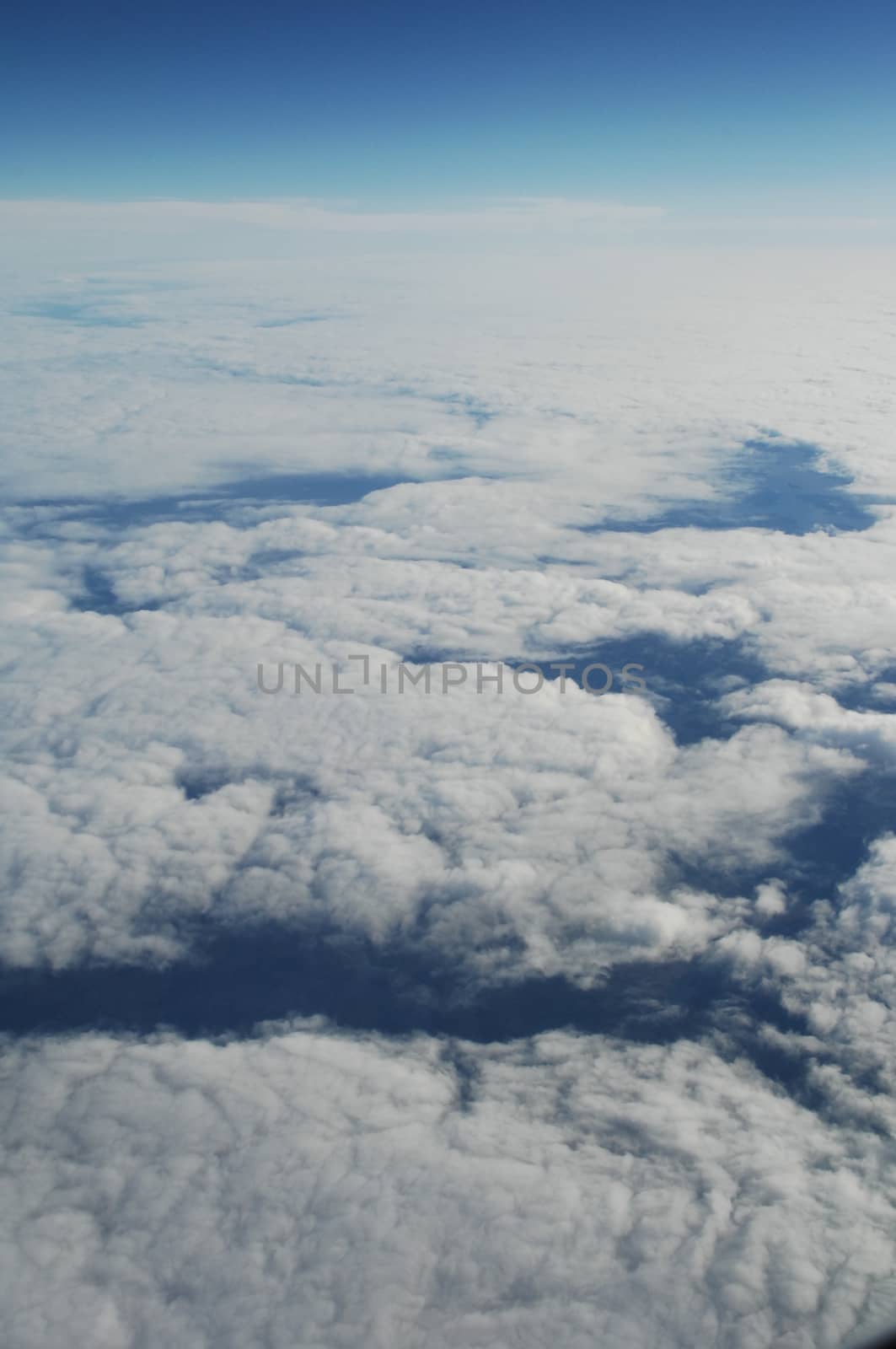 Aerial view of Clouds through flight window