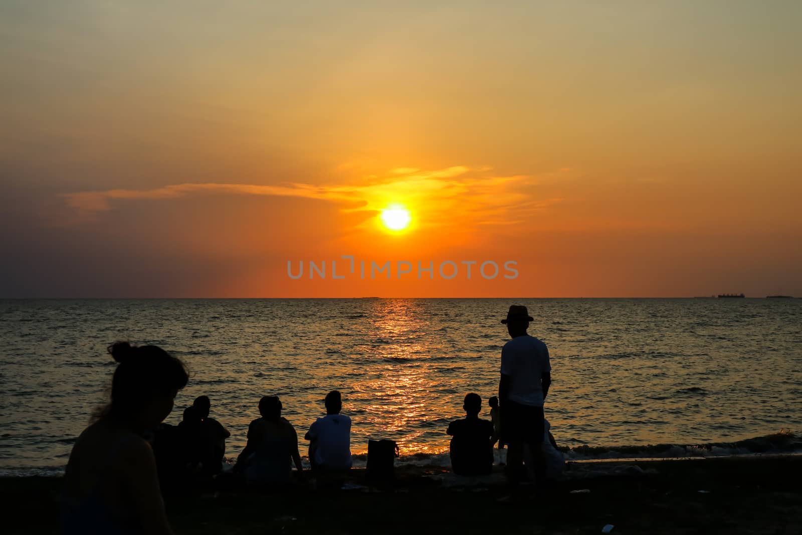 silhouette people family and pet playing at beach and sea sand sunset background