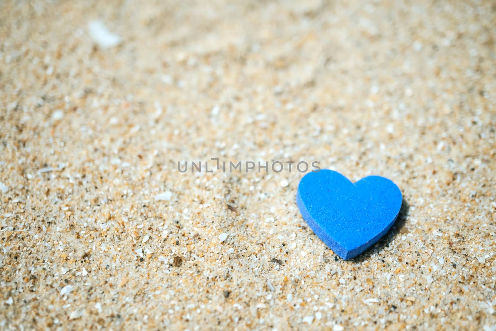 Heart shape on sand at summer beach with copy space. Valentine day concept. by Suwant