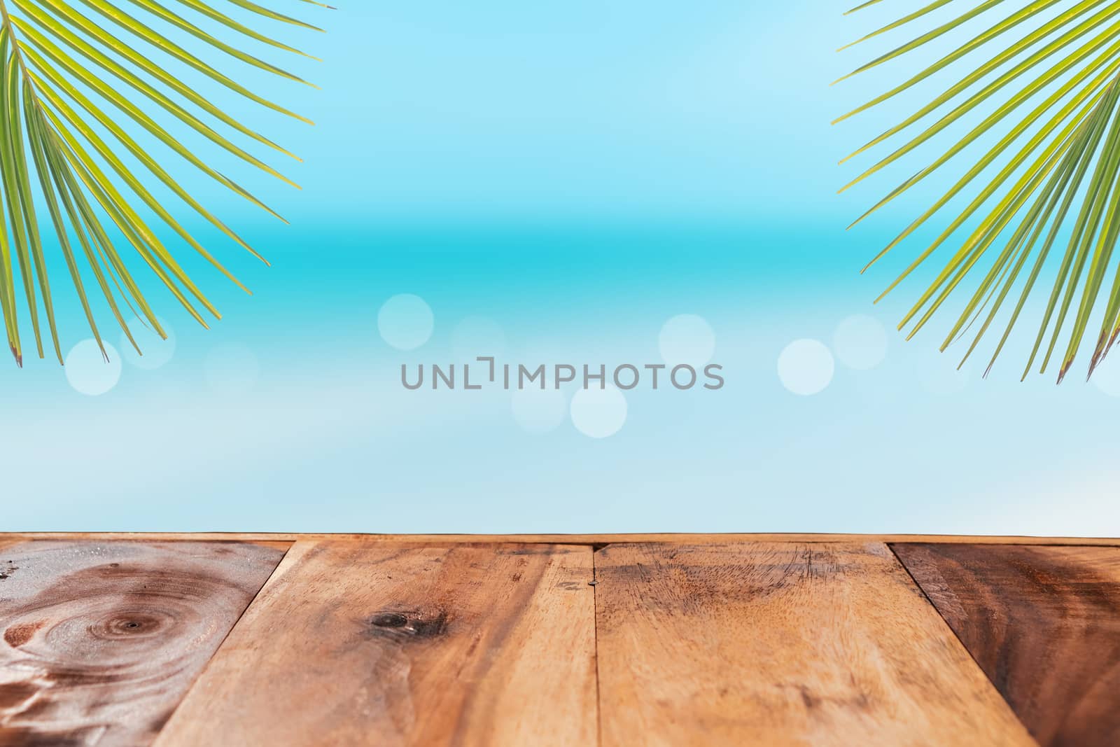Selective focus of old wood table with beach in summer and  blue sky background for display your product.