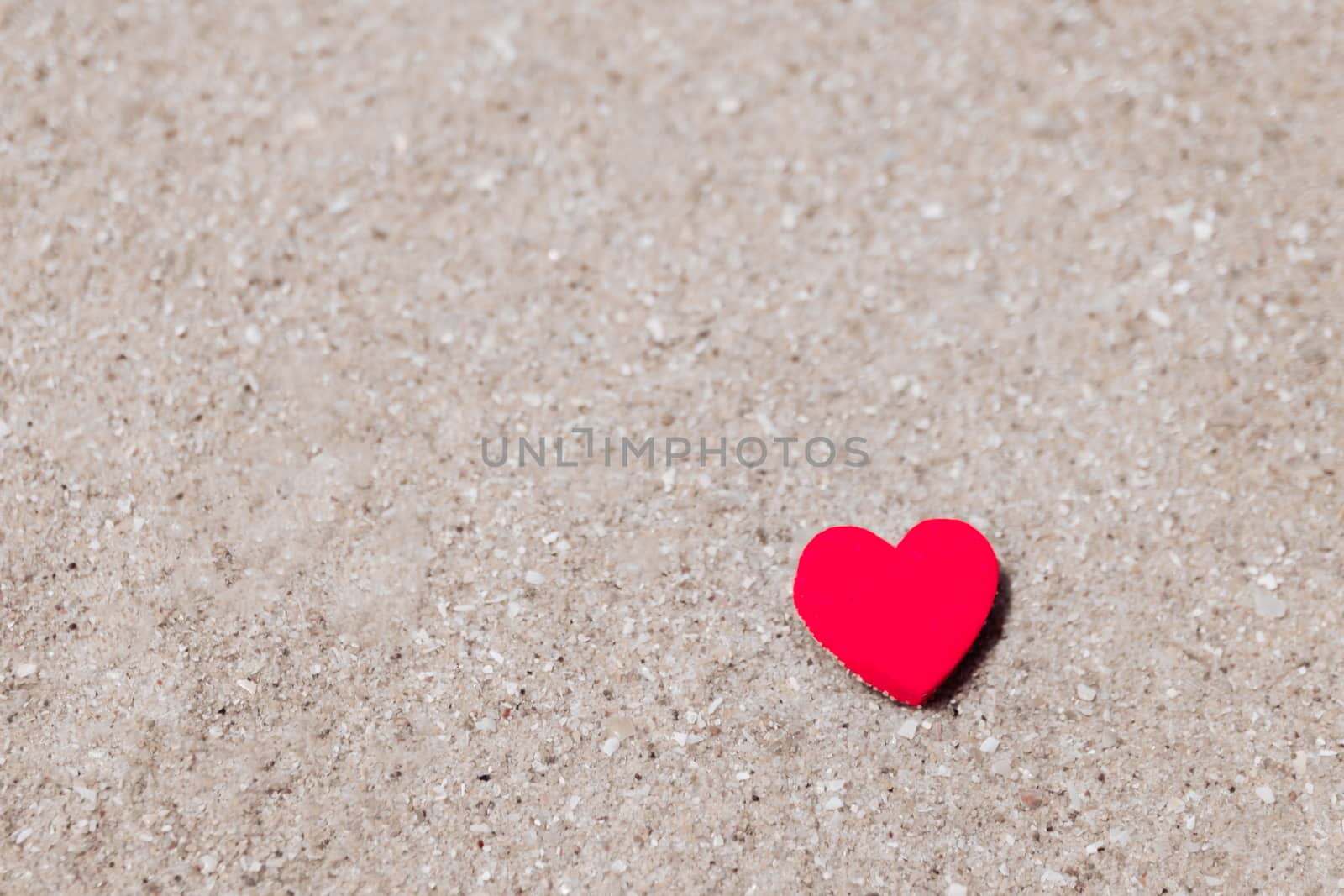 Heart shape on sand at summer beach with copy space. Valentine day concept. by Suwant